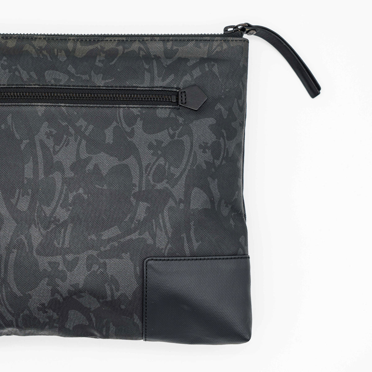 Vivienne Westwood clutch bag in grey and black graphic camouflage with matte black Orb logo and leather trim, styled against a white background.