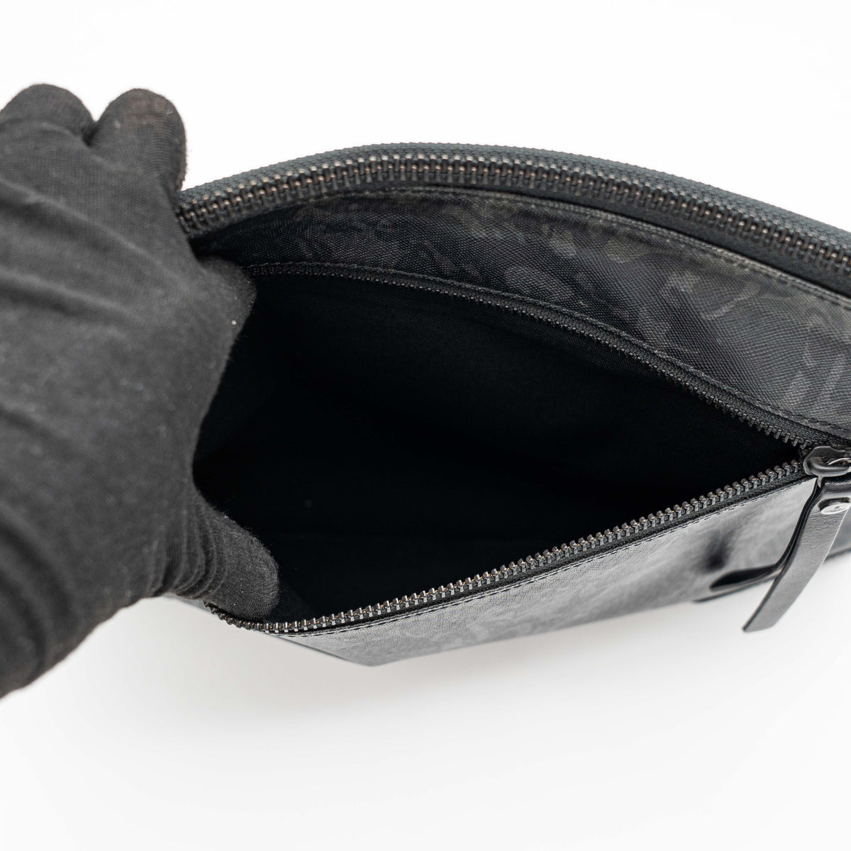 Vivienne Westwood clutch bag in grey and black graphic camouflage with matte black Orb logo and leather trim, styled against a white background.