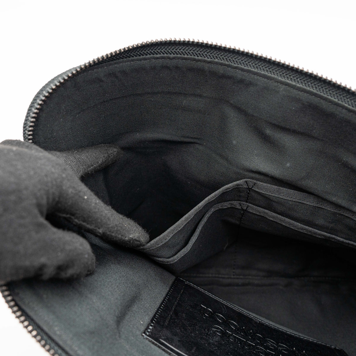 Vivienne Westwood clutch bag in grey and black graphic camouflage with matte black Orb logo and leather trim, styled against a white background.