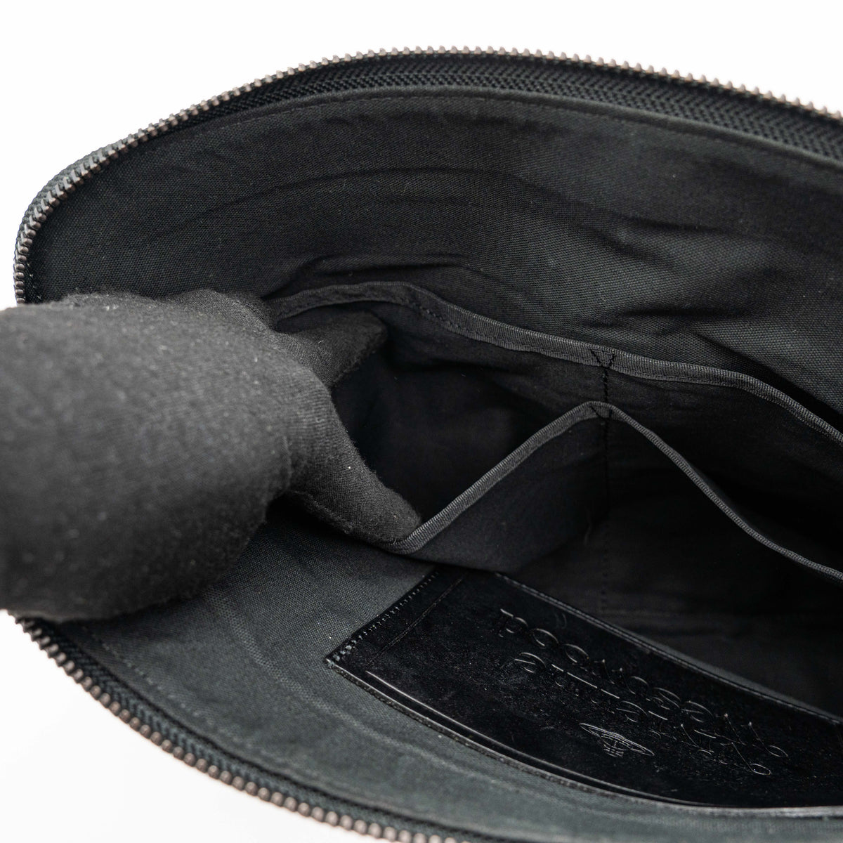 Vivienne Westwood clutch bag in grey and black graphic camouflage with matte black Orb logo and leather trim, styled against a white background.