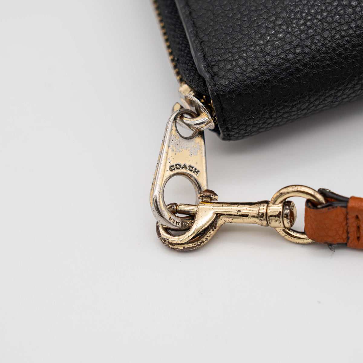 Coach Horse Carriage long zip around wallet in black pebbled leather with wristlet strap, featuring the embossed horse and carriage motif.
