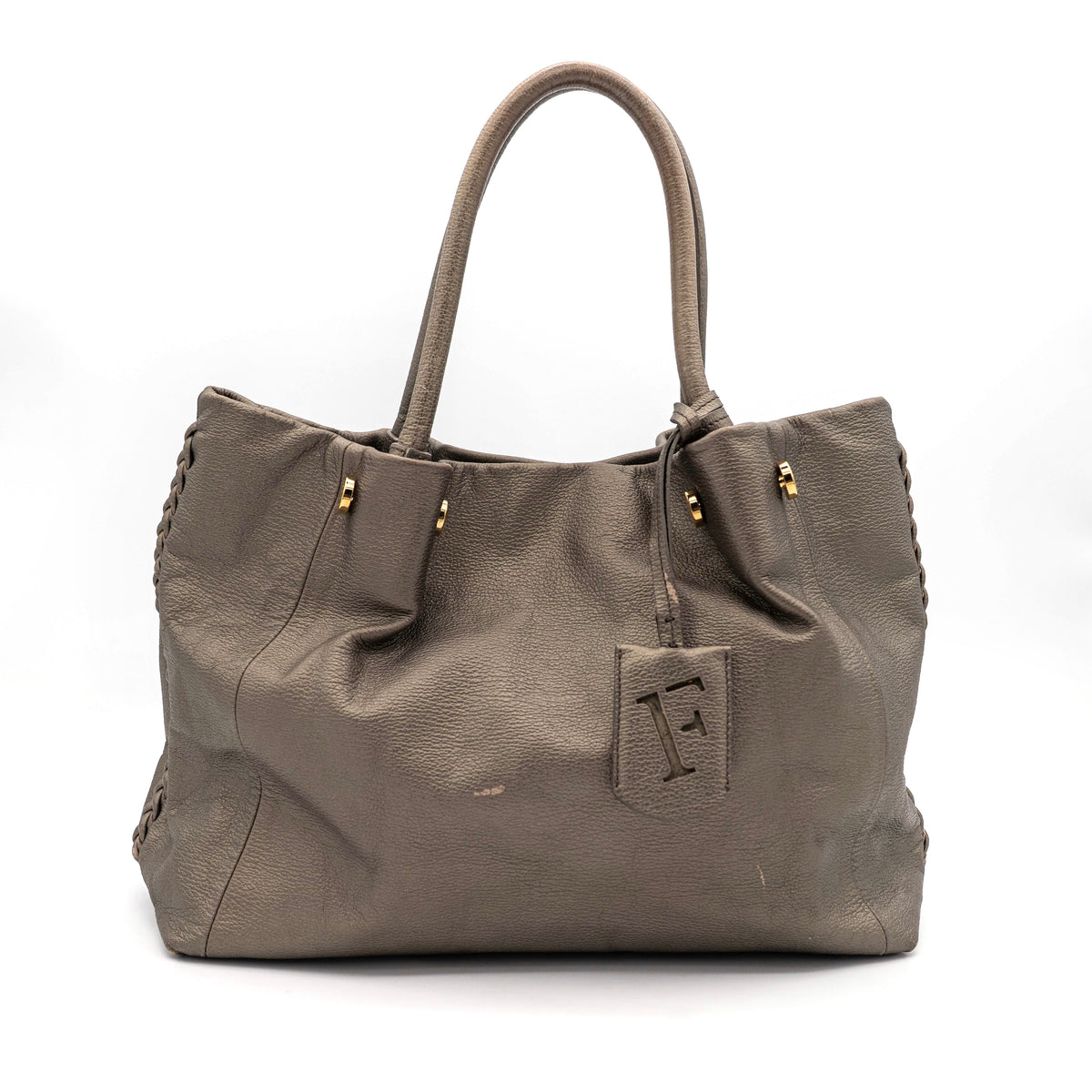 Furla taupe leather shoulder bag with gold hardware and braided detailing, photographed against a white background.