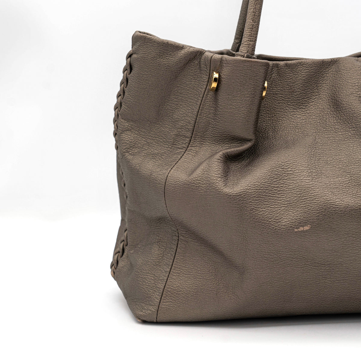 Furla taupe leather shoulder bag with gold hardware and braided detailing, photographed against a white background.