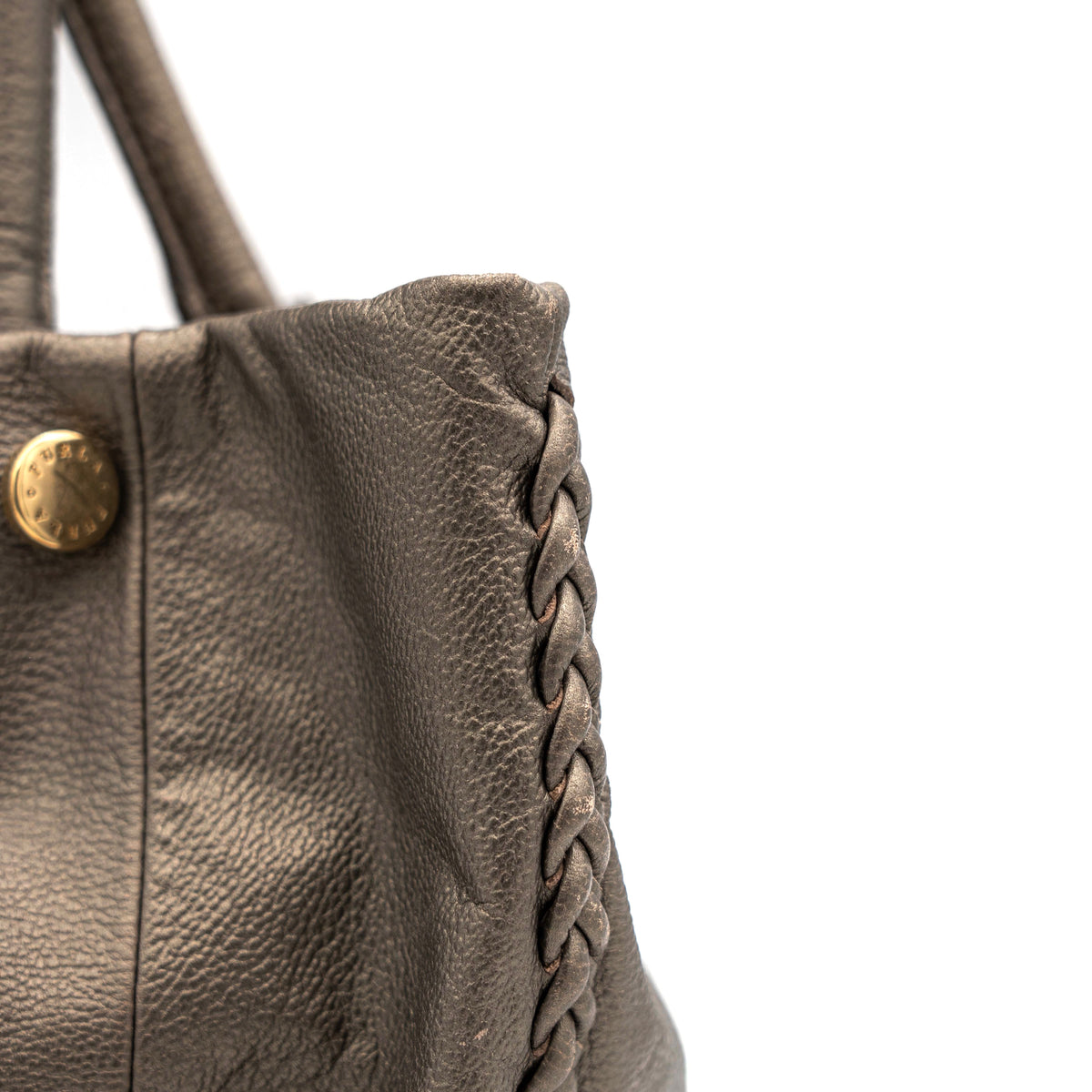 Furla taupe leather shoulder bag with gold hardware and braided detailing, photographed against a white background.