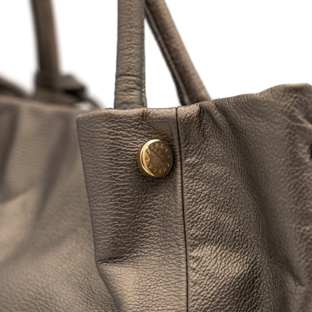 Furla taupe leather shoulder bag with gold hardware and braided detailing, photographed against a white background.