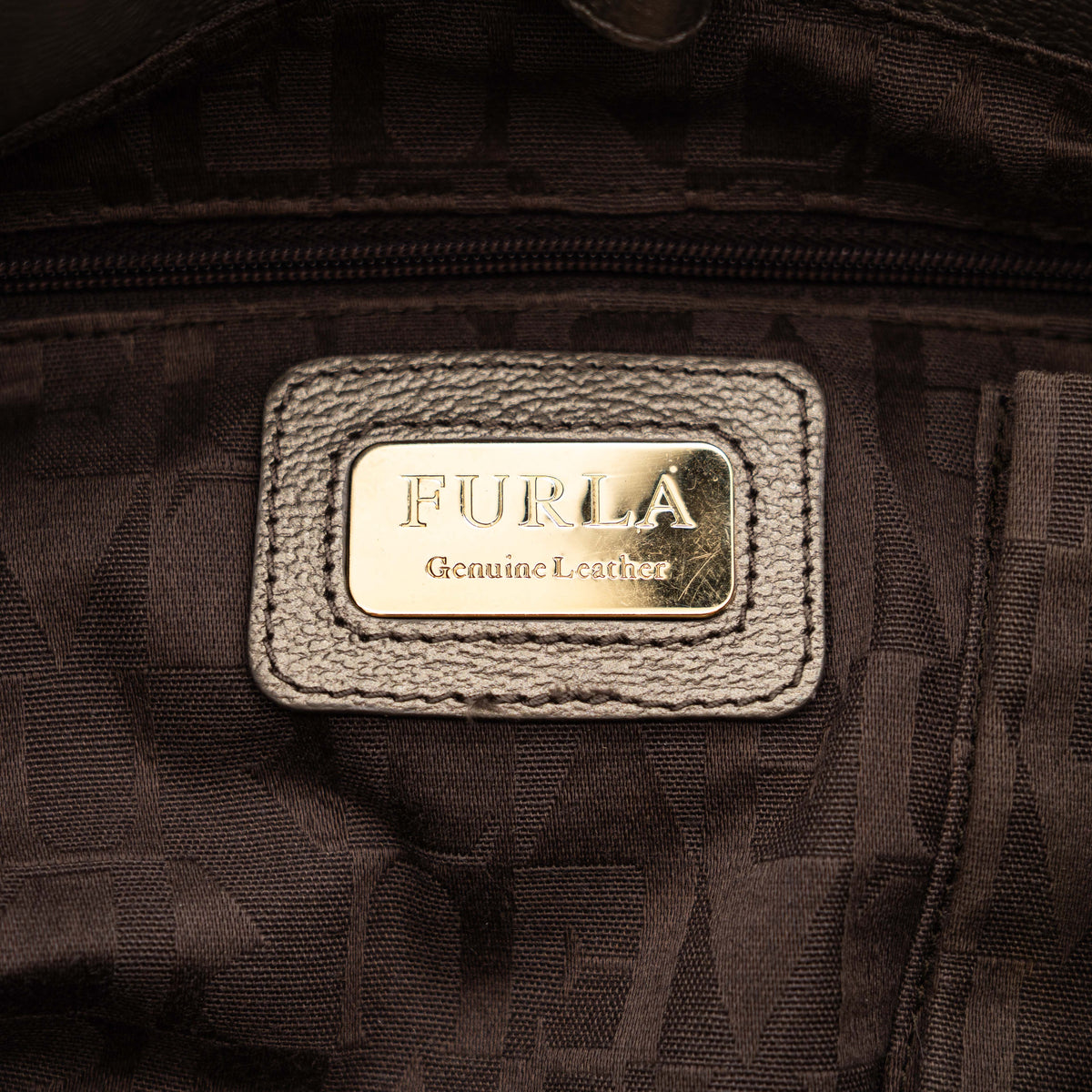 Furla taupe leather shoulder bag with gold hardware and braided detailing, photographed against a white background.
