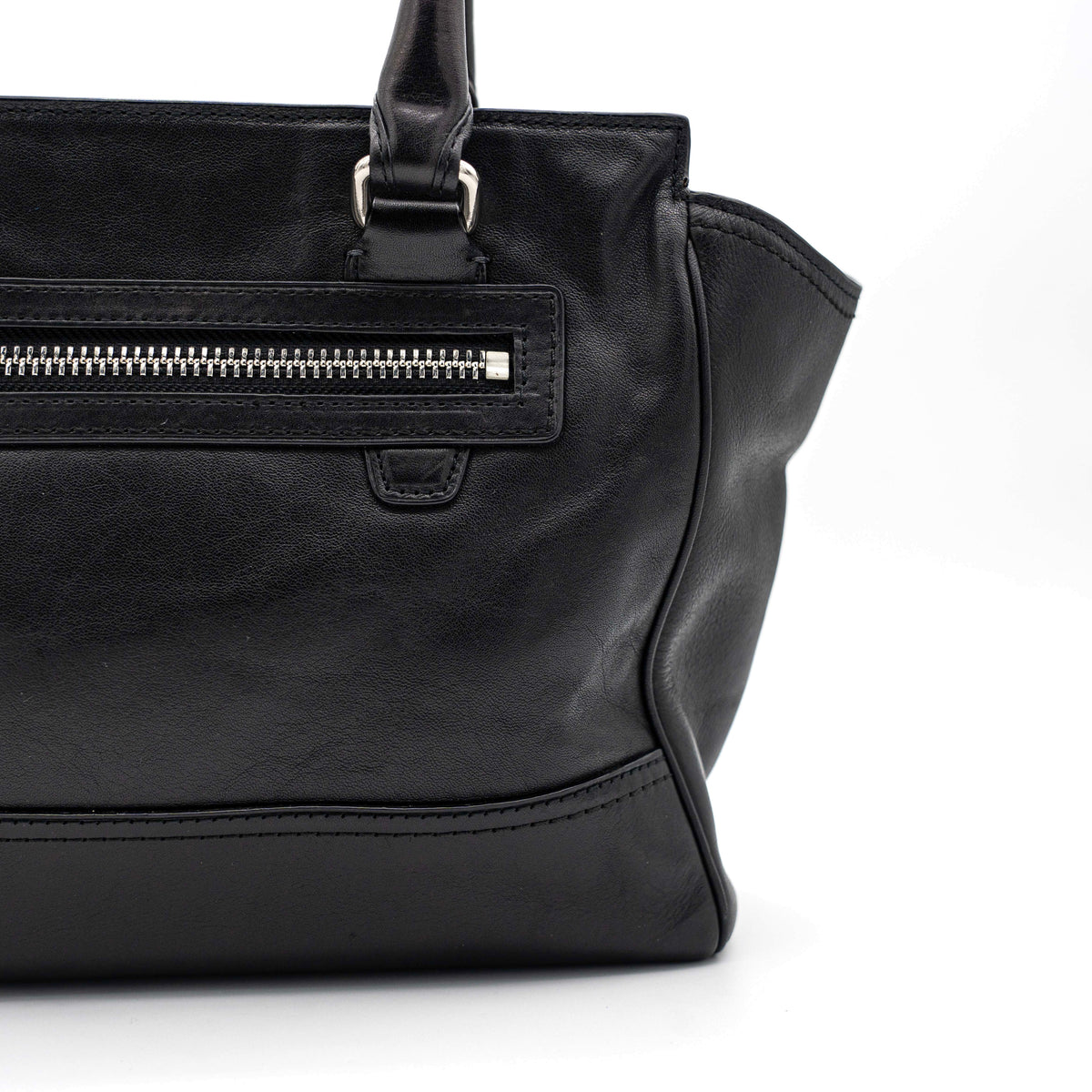Coach Legacy Candace Carryall in black leather with double tassel charm and silver hardware, photographed against a white background.