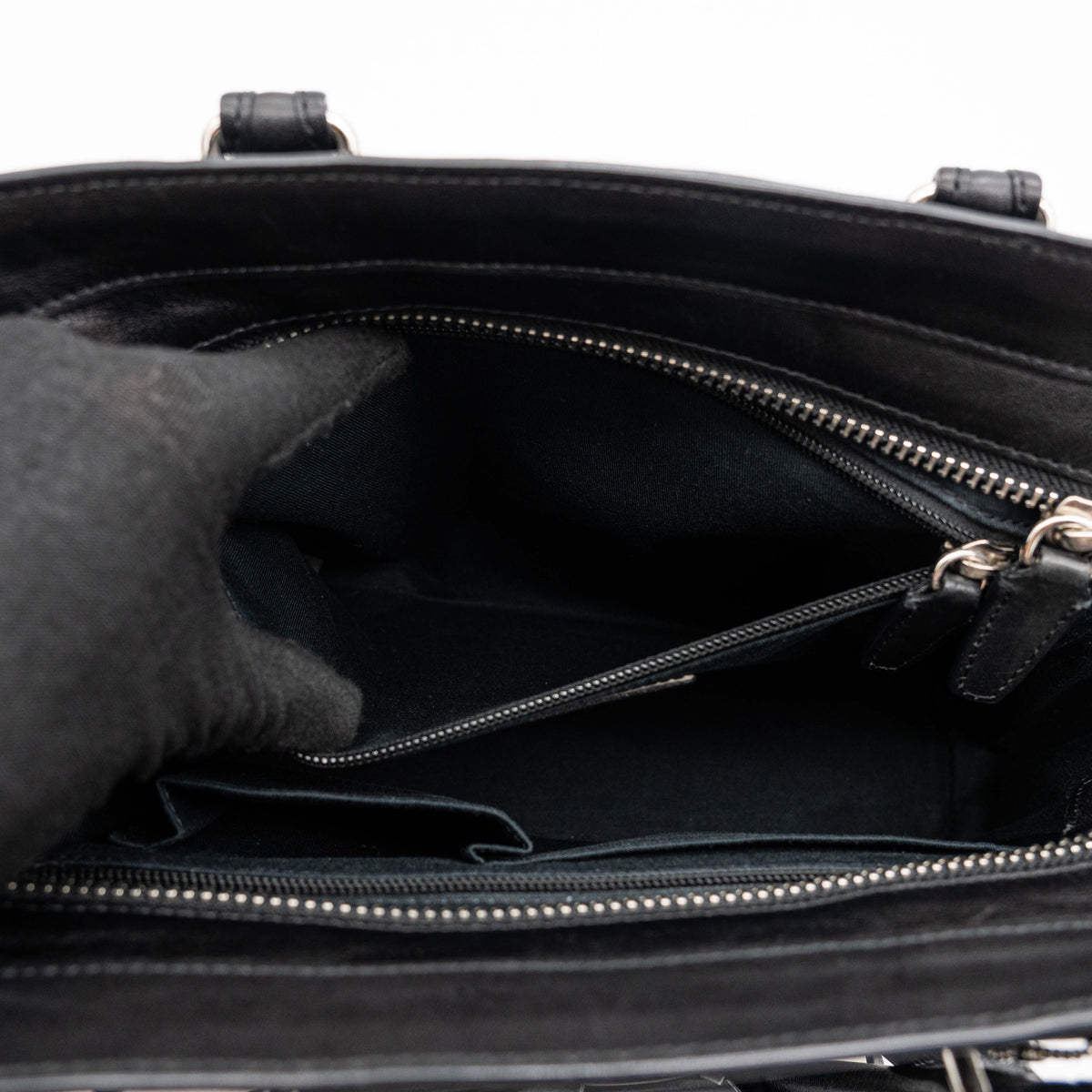 Coach Legacy Candace Carryall in black leather with double tassel charm and silver hardware, photographed against a white background.