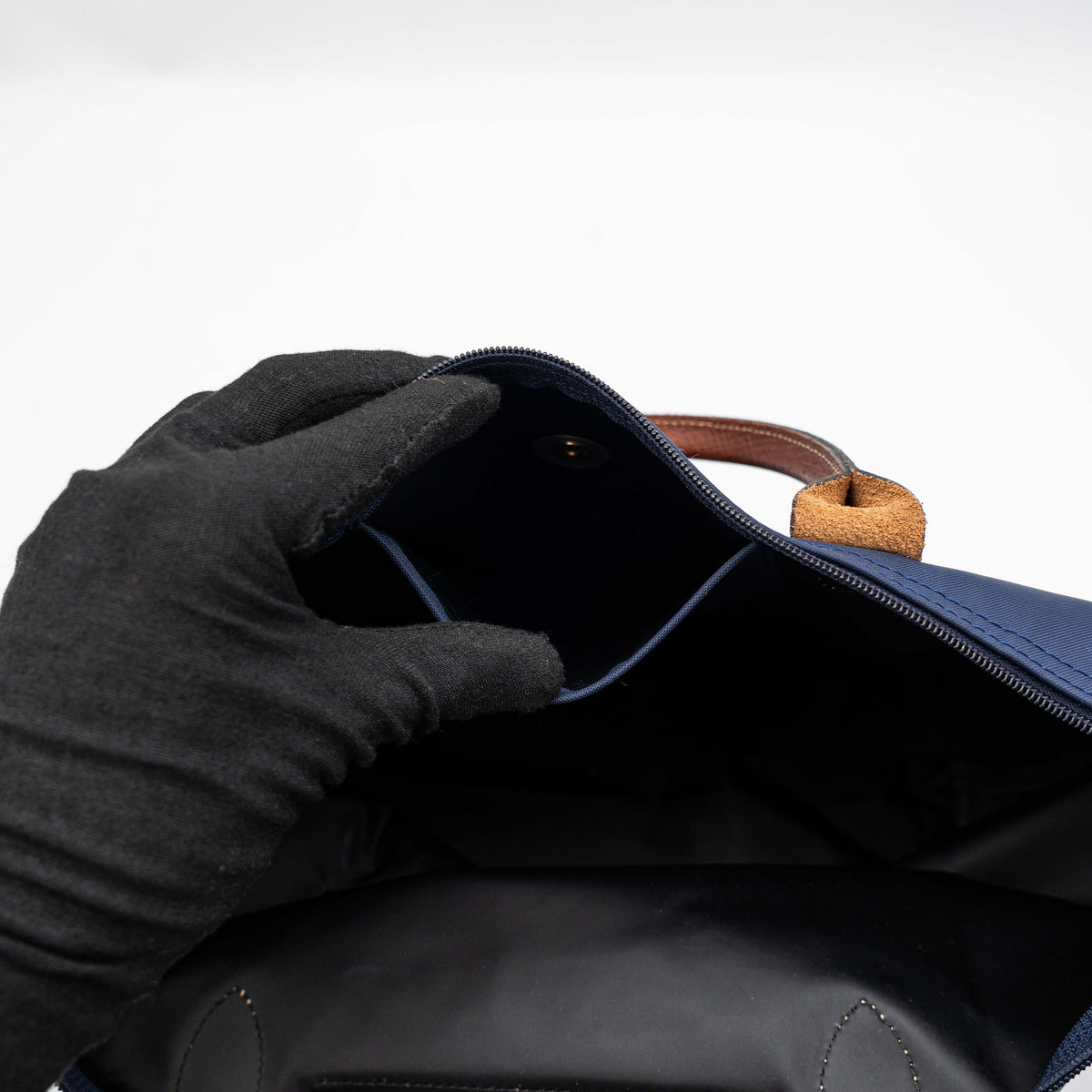 Longchamp Le Pliage Original handbag in navy blue nylon with brown leather handles and trim, shown against a white background.