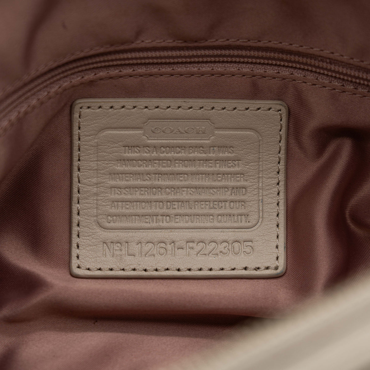 Coach Signature Kristin Satchel handbag in beige and cream jacquard with leather trim and detachable strap, displayed against a white background.