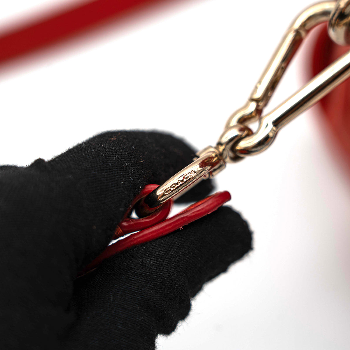 Coach Swagger 27 Carryall in textured red leather with gold hardware, shown with detachable shoulder strap.
