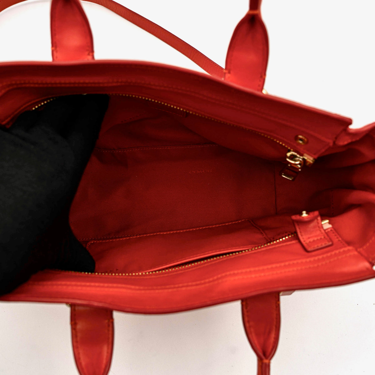 Coach Swagger 27 Carryall in textured red leather with gold hardware, shown with detachable shoulder strap.