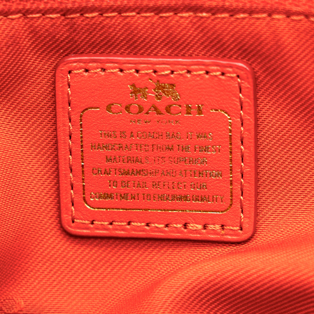 Coach Swagger 27 Carryall in textured red leather with gold hardware, shown with detachable shoulder strap.