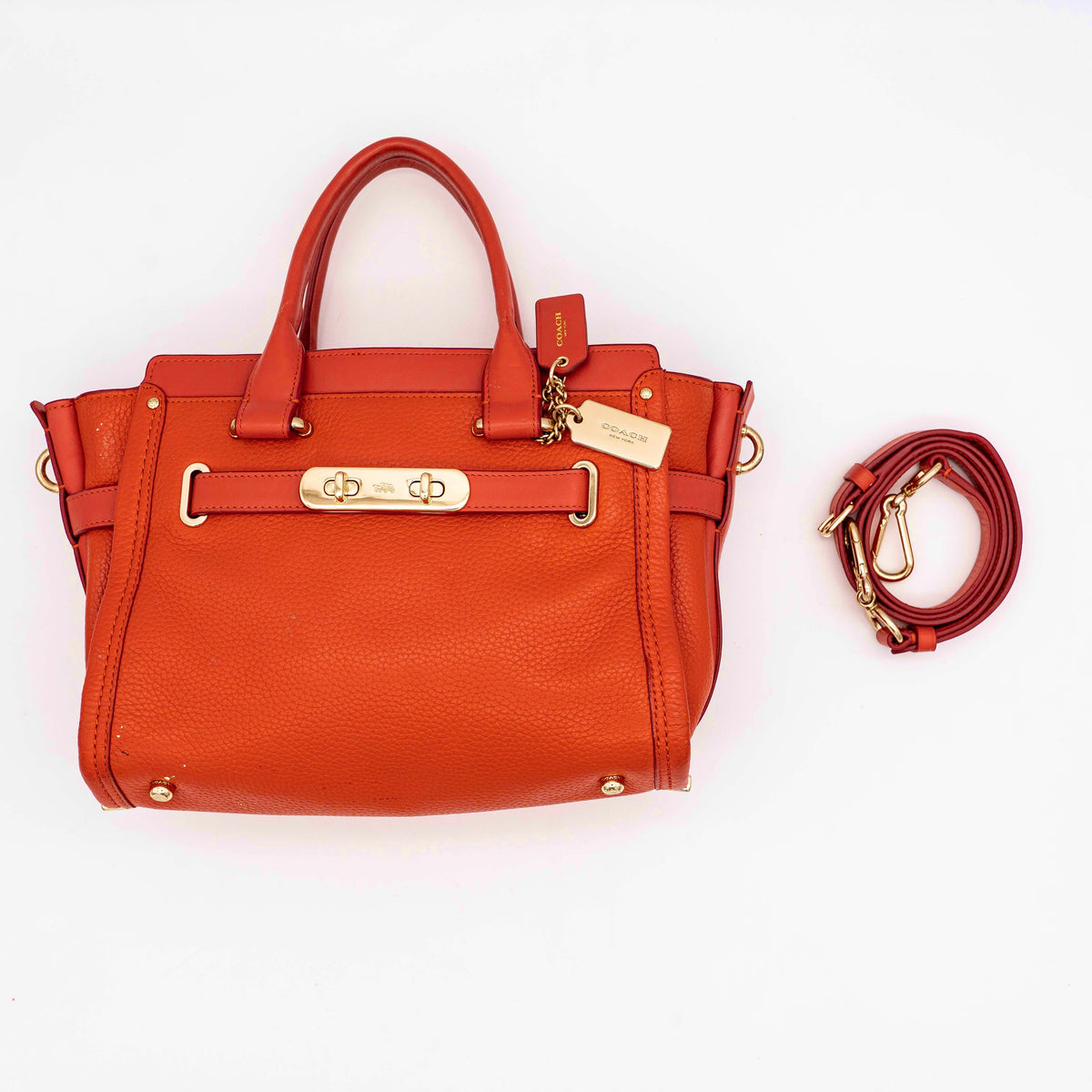 Coach Swagger 27 Carryall in textured red leather with gold hardware, shown with detachable shoulder strap.