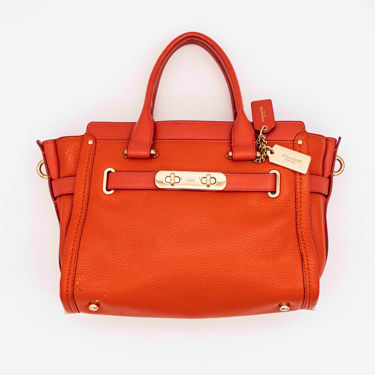Coach Swagger 27 Carryall in textured red leather with gold hardware, shown with detachable shoulder strap.