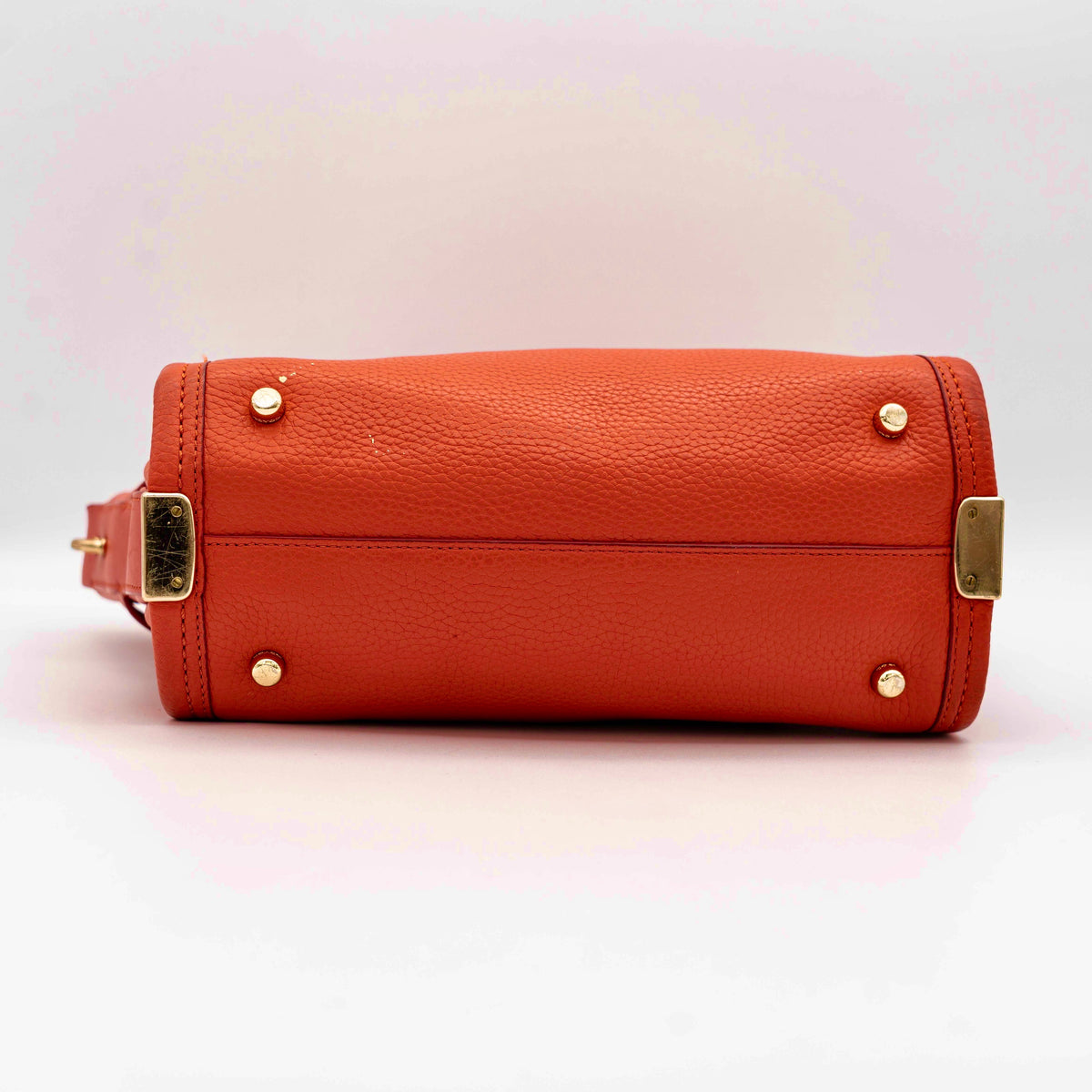 Coach Swagger 27 Carryall in textured red leather with gold hardware, shown with detachable shoulder strap.