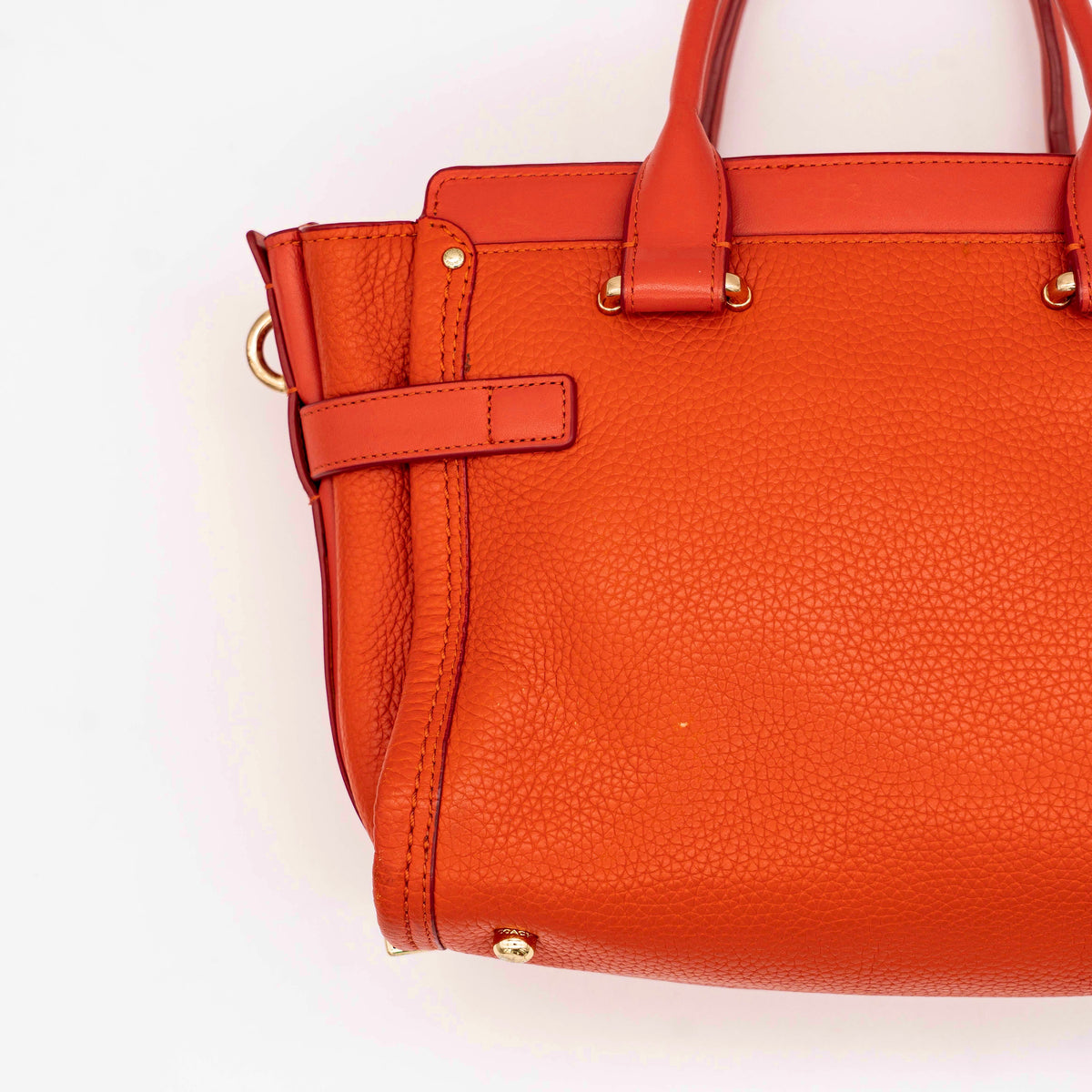 Coach Swagger 27 Carryall in textured red leather with gold hardware, shown with detachable shoulder strap.