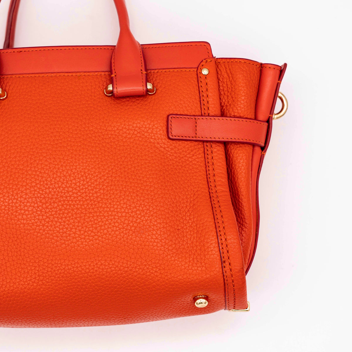 Coach Swagger 27 Carryall in textured red leather with gold hardware, shown with detachable shoulder strap.