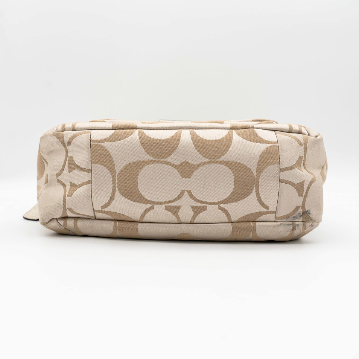 Coach Signature Kristin Satchel handbag in beige and cream jacquard with leather trim and detachable strap, displayed against a white background.