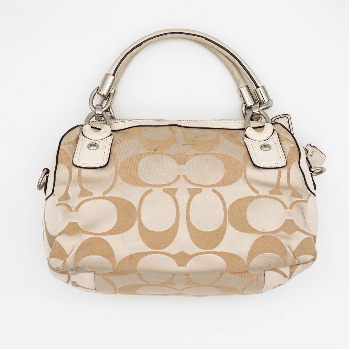 Coach Signature Kristin Satchel handbag in beige and cream jacquard with leather trim and detachable strap, displayed against a white background.