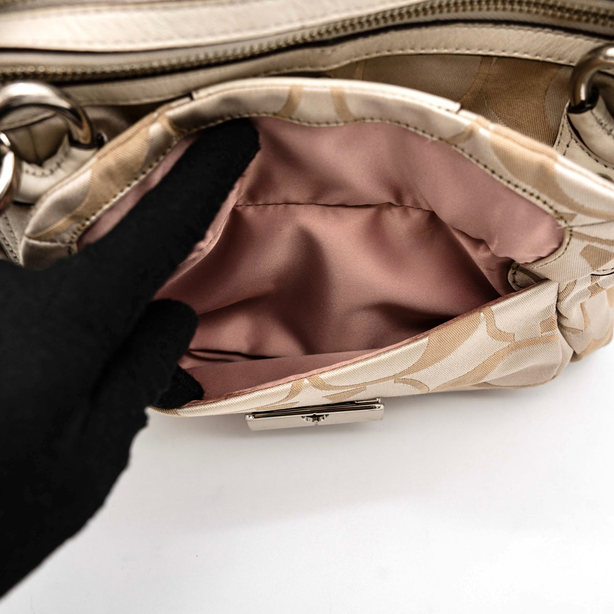 Coach Signature Kristin Satchel handbag in beige and cream jacquard with leather trim and detachable strap, displayed against a white background.