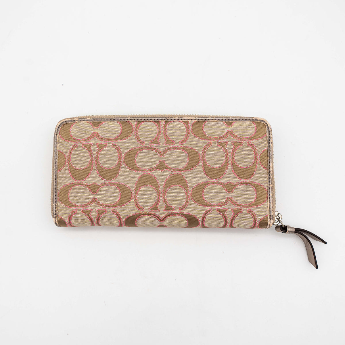 Coach Signature Daisy Accordion Zip Wallet in beige and pink canvas with zip pocket and metallic trim, photographed on a white background.