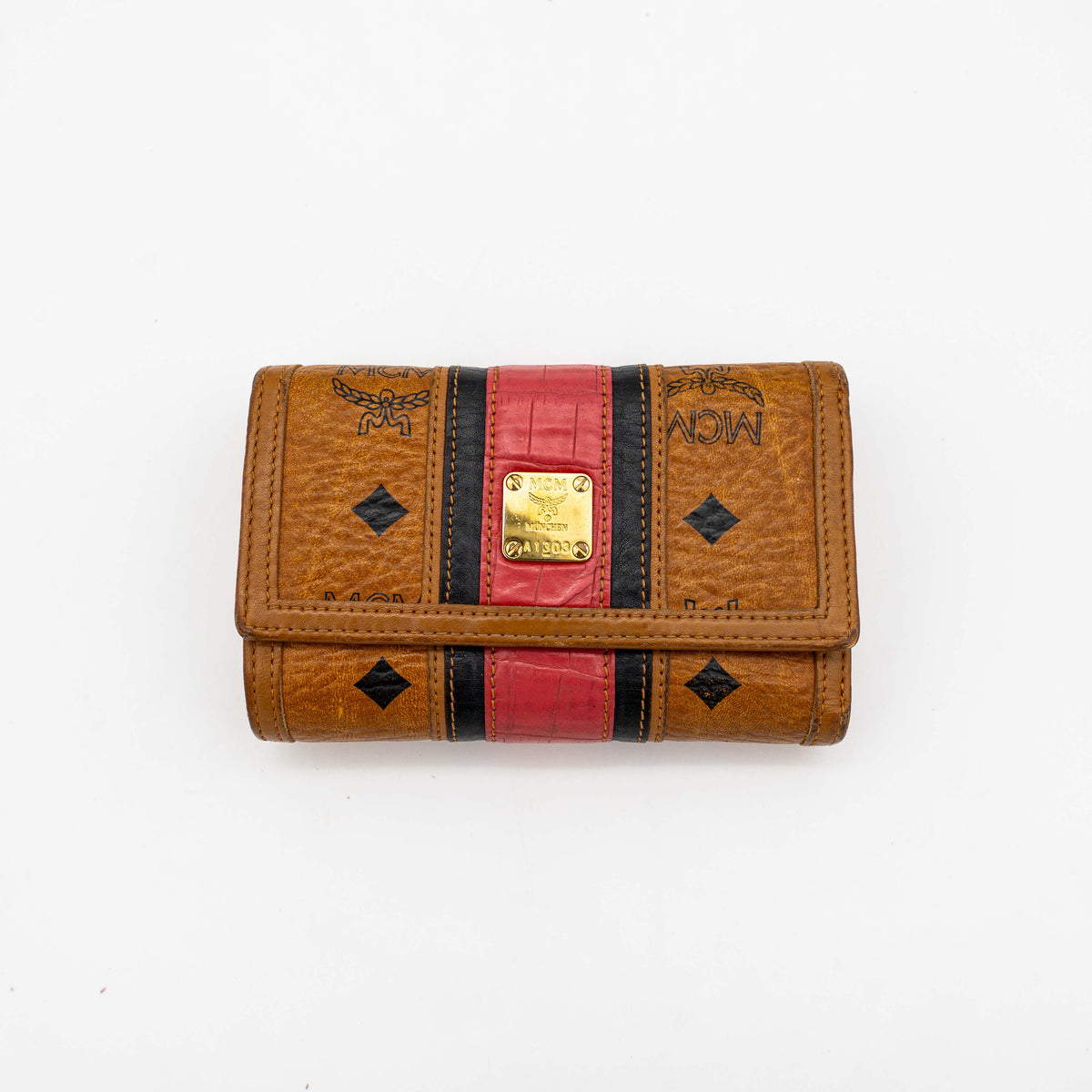 Front view of the MCM Cognac Visetos Monogram Stripe Trifold Wallet in brown with red and black accents and gold logo plaque.