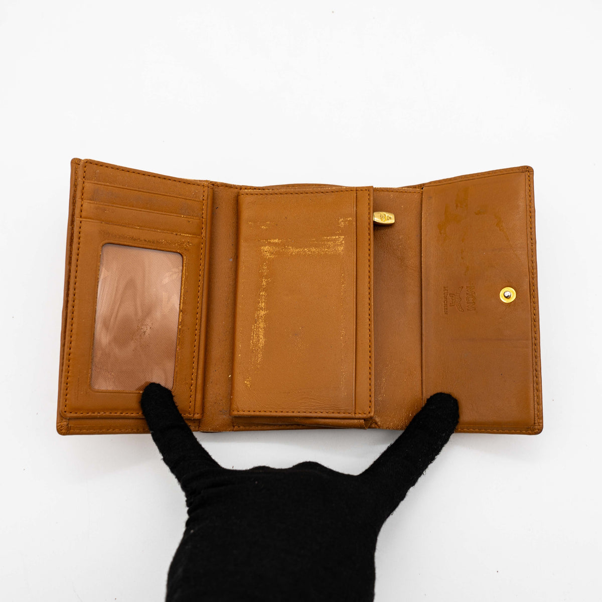 Front view of the MCM Cognac Visetos Monogram Stripe Trifold Wallet in brown with red and black accents and gold logo plaque.