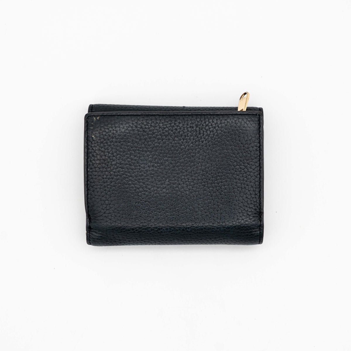 Furla Dafne black trifold wallet in pebbled leather with gold-tone hardware and logo plaque on the front.