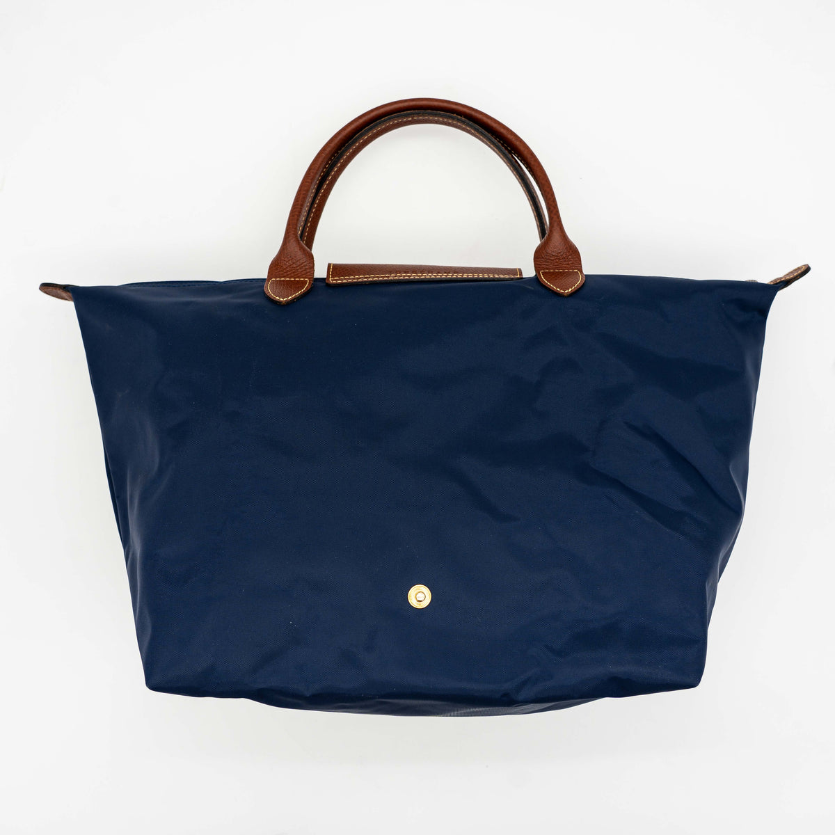 Longchamp Le Pliage Original handbag in navy blue nylon with brown leather handles and trim, shown against a white background.