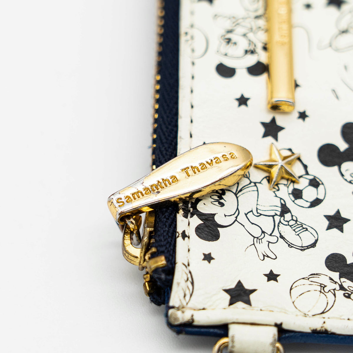Samantha Thavasa Sports Mickey Collection card case in ivory and blue with gold chain and playful Mickey Mouse sports illustrations.
