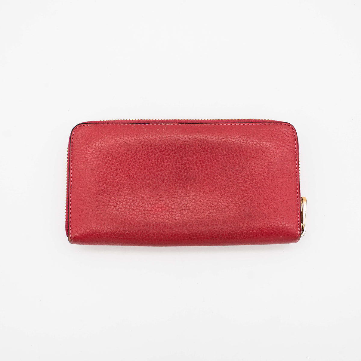 Coach Horse And Carriage Long Zip Around Wallet in red grained leather with gold-tone hardware and embossed logo, shown against a white background.