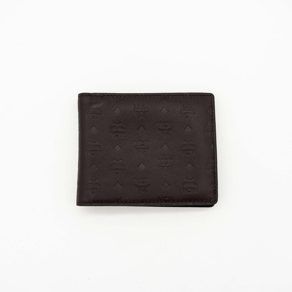 MCM dark brown leather bifold wallet with embossed Visetos monogram pattern shown against a white background.