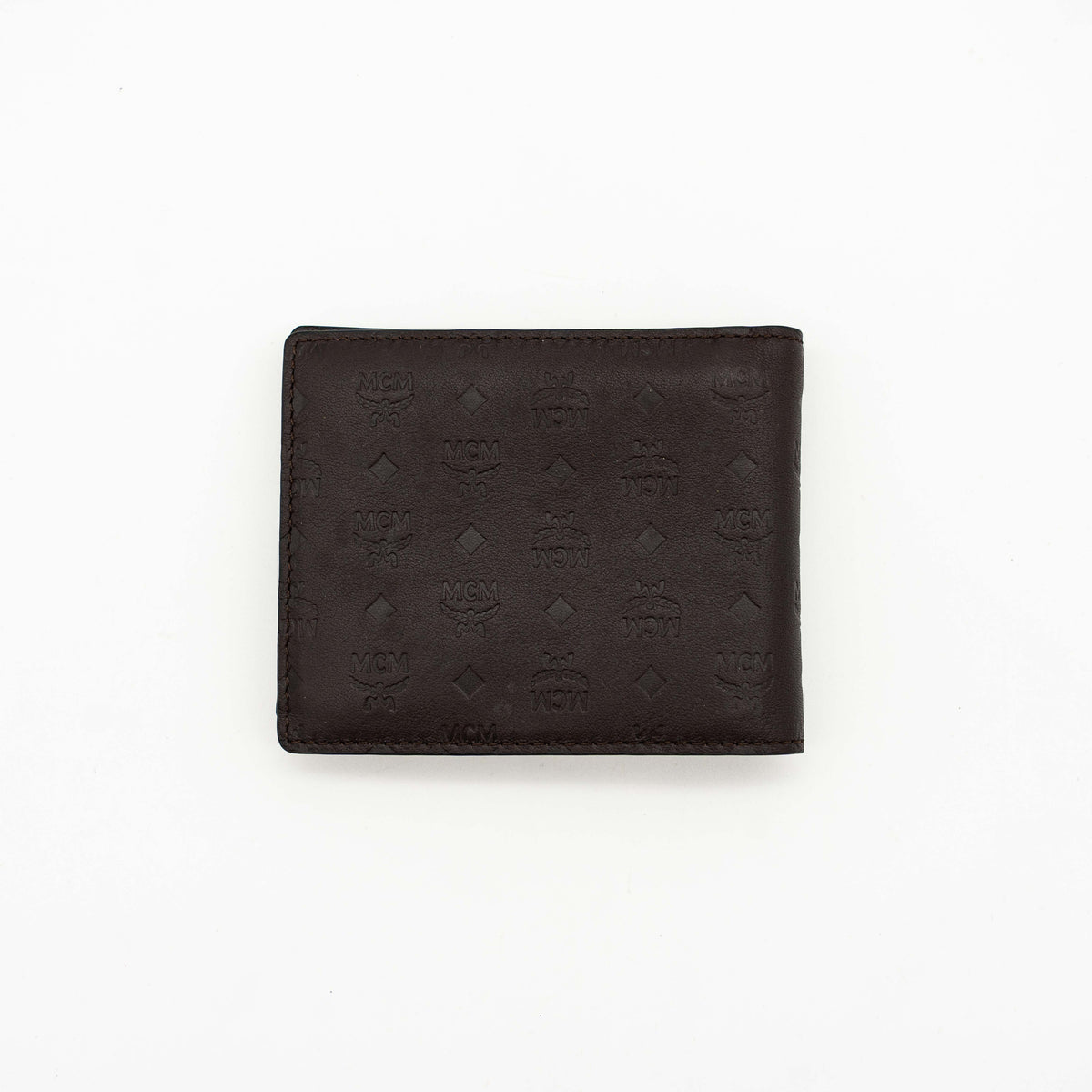 MCM dark brown leather bifold wallet with embossed Visetos monogram pattern shown against a white background.