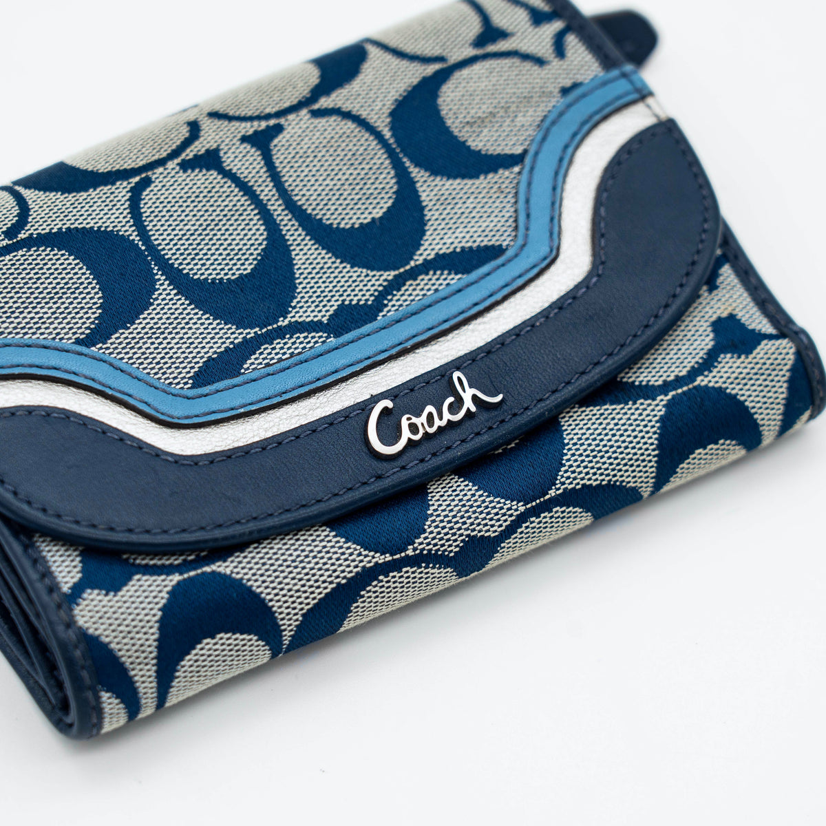 Coach Signature Ashley compact wallet in blue jacquard with leather trim, featuring a silver logo and organized interior.
