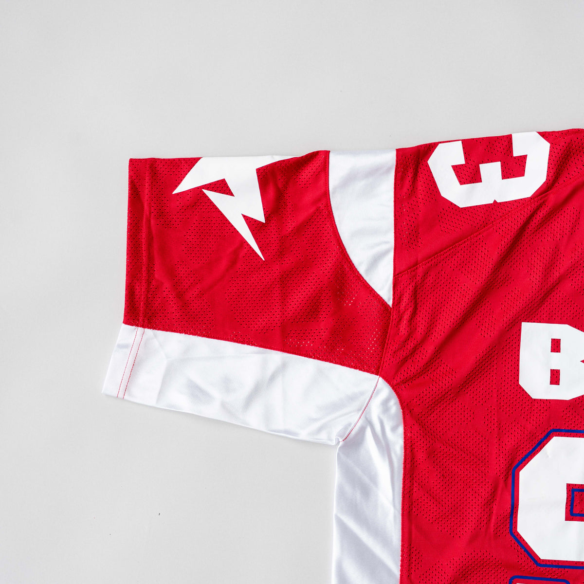 Front view of BAPE Solid Camo Jacquard Mesh Cropped Fit Football Jersey in red and white with bold '93' print and original tags.