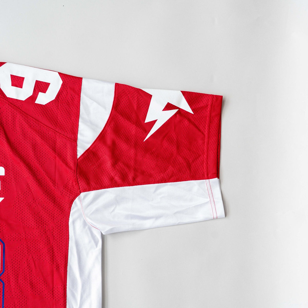 Front view of BAPE Solid Camo Jacquard Mesh Cropped Fit Football Jersey in red and white with bold '93' print and original tags.
