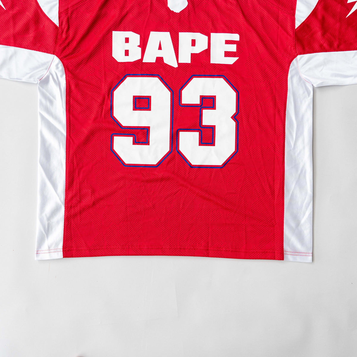 Front view of BAPE Solid Camo Jacquard Mesh Cropped Fit Football Jersey in red and white with bold '93' print and original tags.