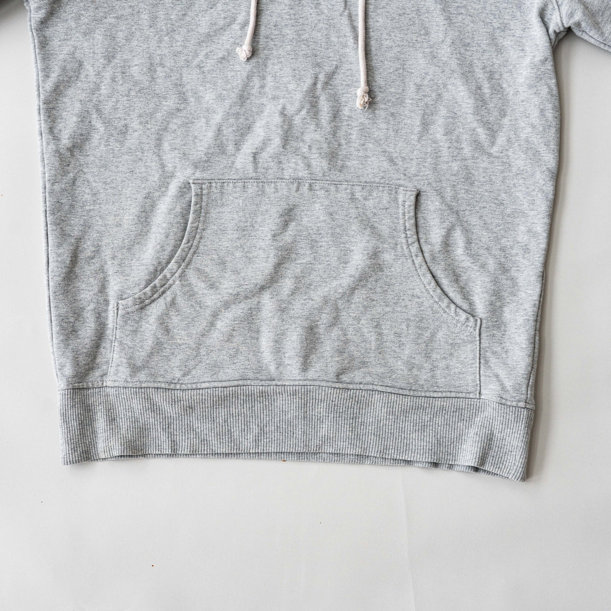 Palace grey pullover hoodie with tropical Tri-Ferg back graphic and white chest logo, laid flat on a neutral background.