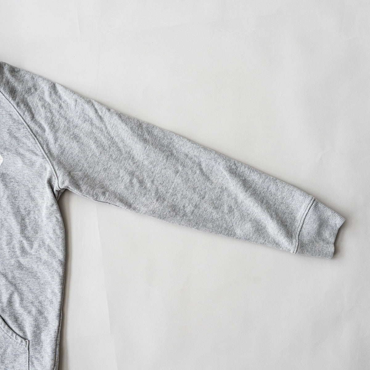 Palace grey pullover hoodie with tropical Tri-Ferg back graphic and white chest logo, laid flat on a neutral background.