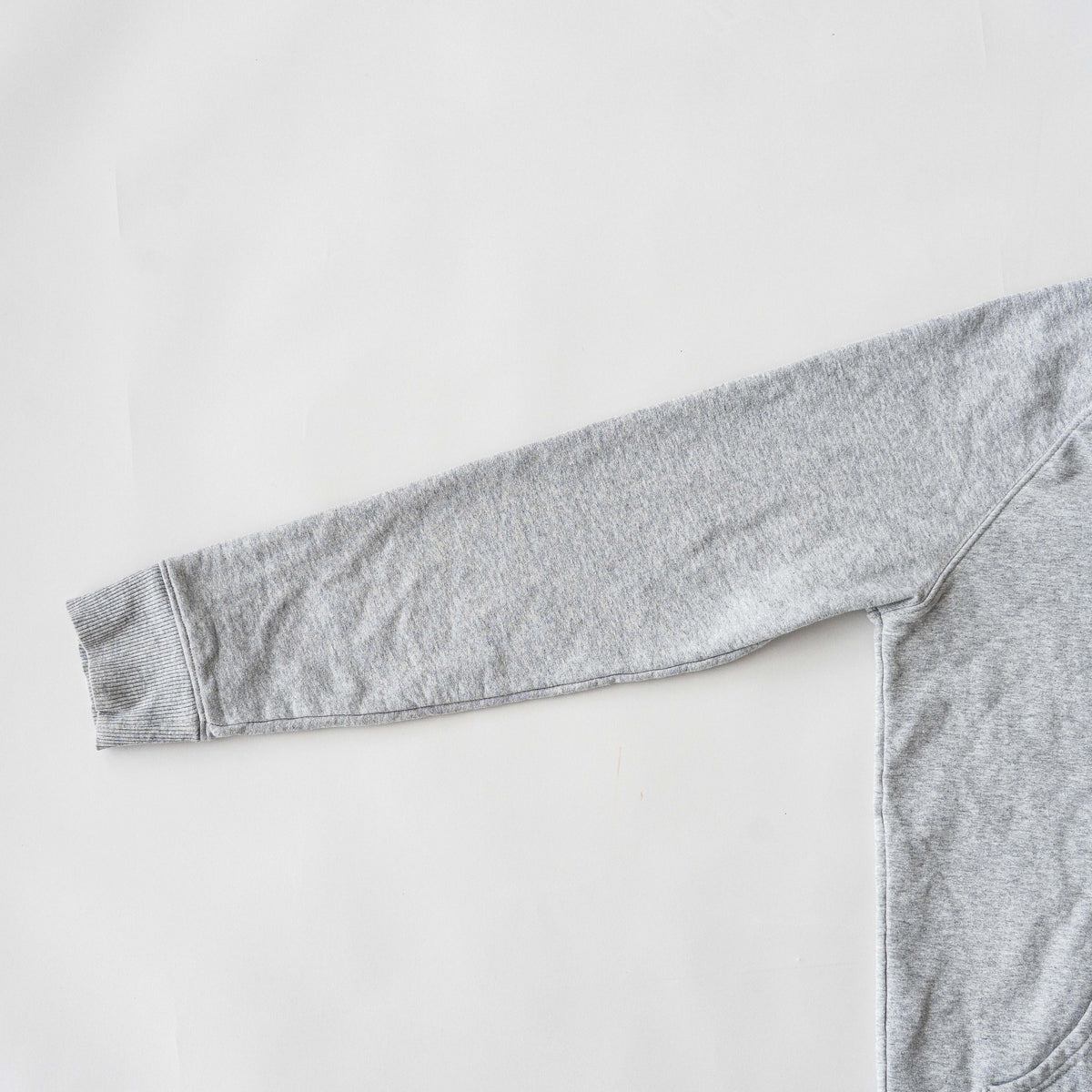Palace grey pullover hoodie with tropical Tri-Ferg back graphic and white chest logo, laid flat on a neutral background.