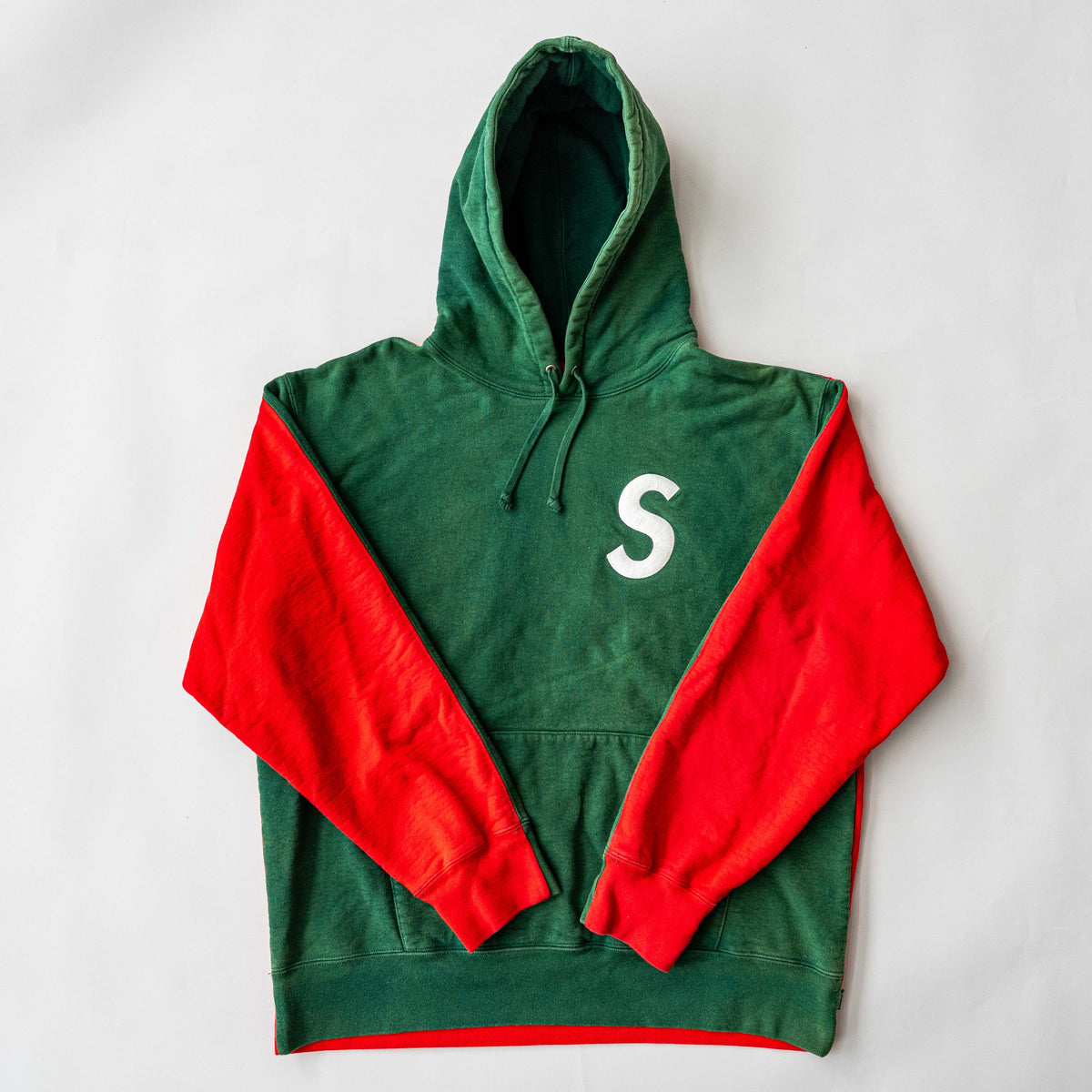 Supreme S Logo Split Hooded Sweatshirt in dark green and red, featuring front 'S' patch and a bold colour contrast.
