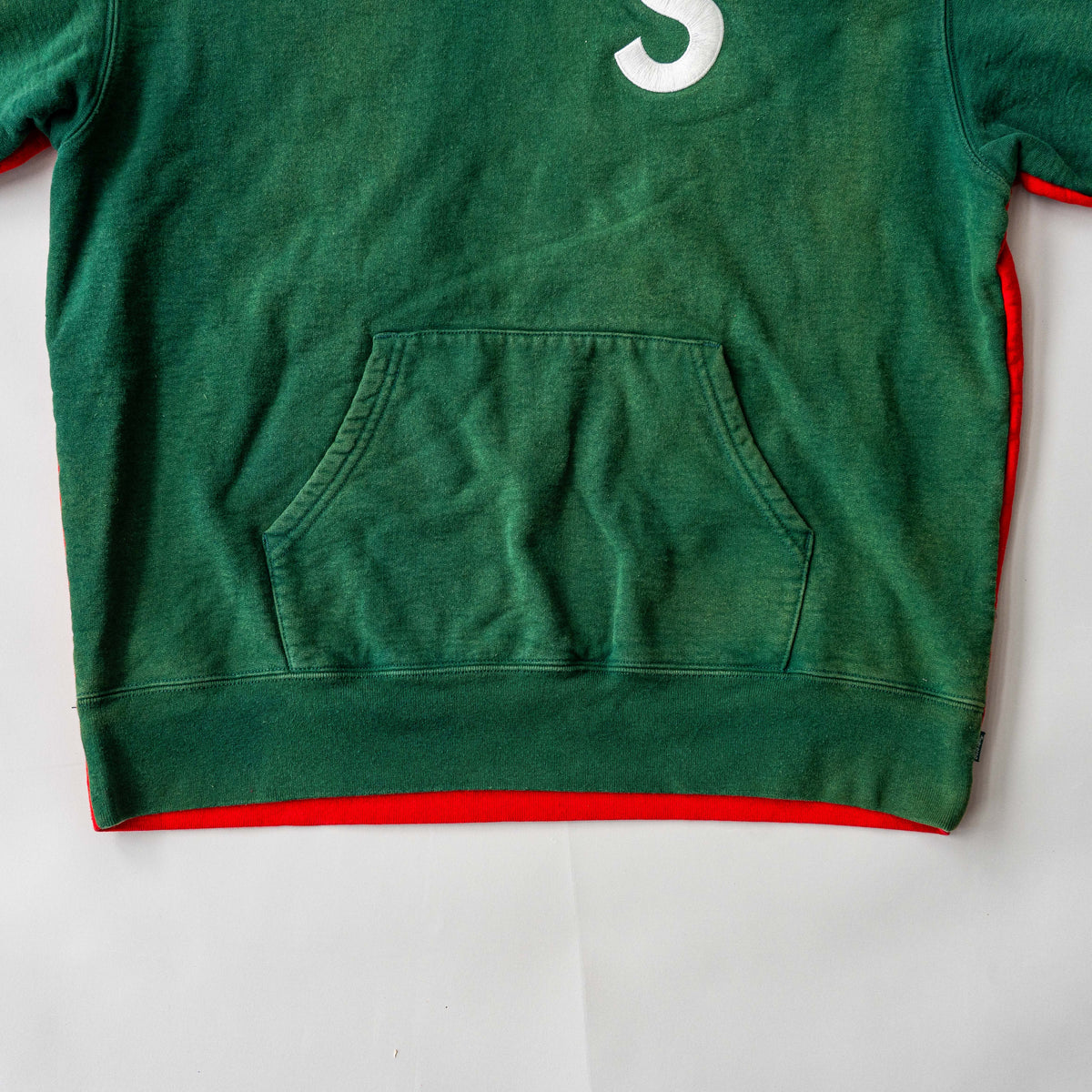 Supreme S Logo Split Hooded Sweatshirt in dark green and red, featuring front 'S' patch and a bold colour contrast.