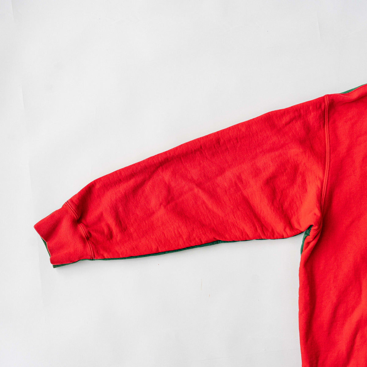 Supreme S Logo Split Hooded Sweatshirt in dark green and red, featuring front 'S' patch and a bold colour contrast.