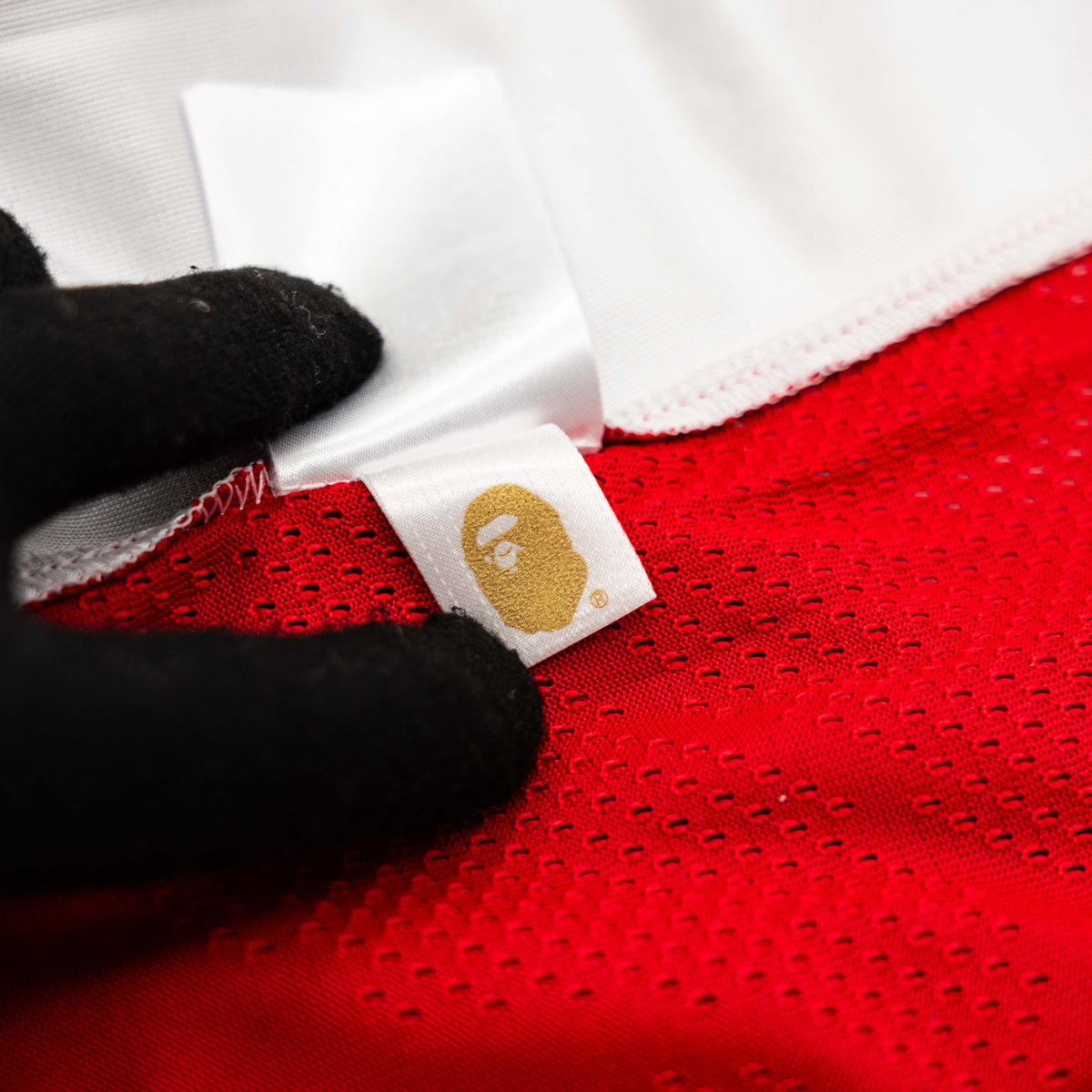 Front view of BAPE Solid Camo Jacquard Mesh Cropped Fit Football Jersey in red and white with bold '93' print and original tags.