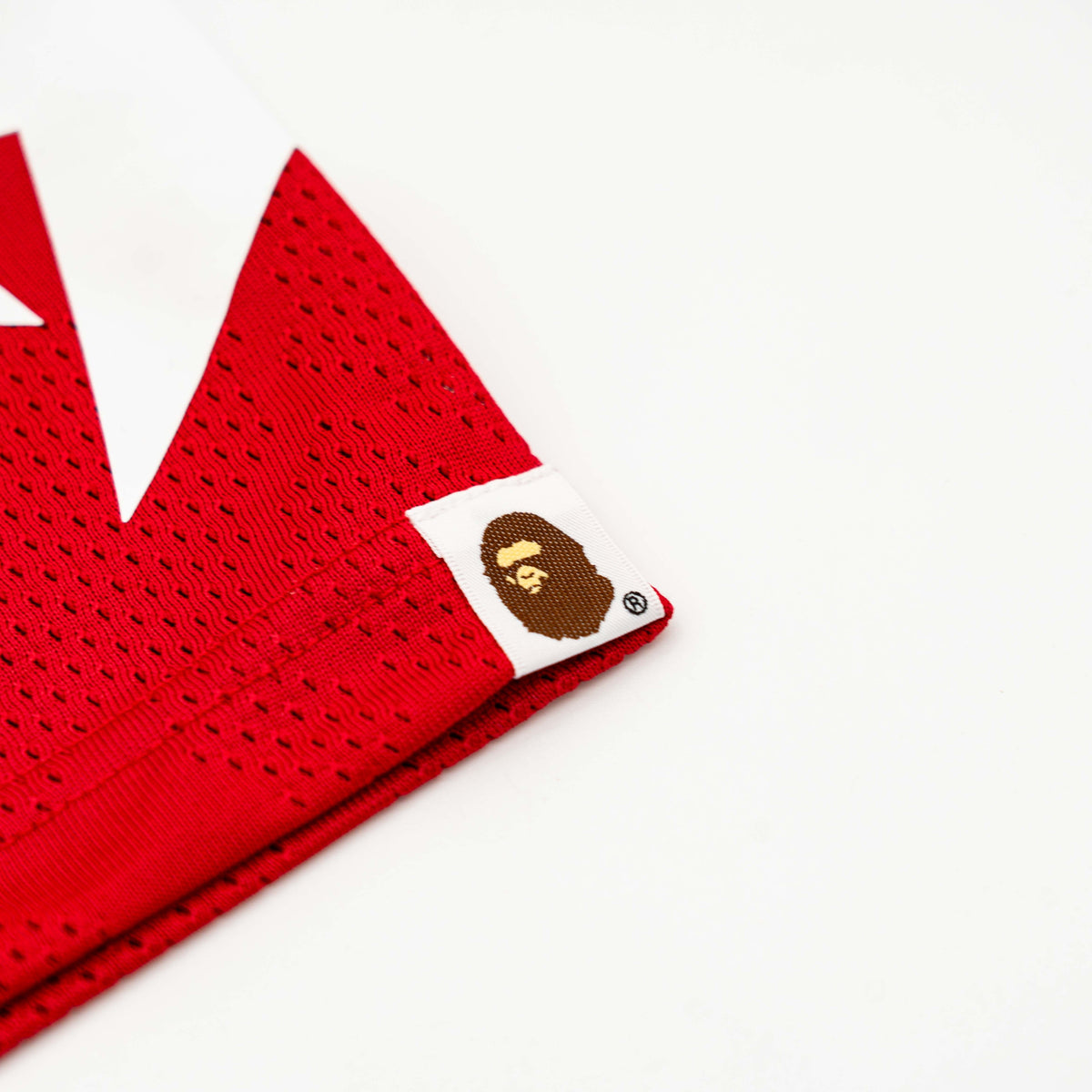 Front view of BAPE Solid Camo Jacquard Mesh Cropped Fit Football Jersey in red and white with bold '93' print and original tags.