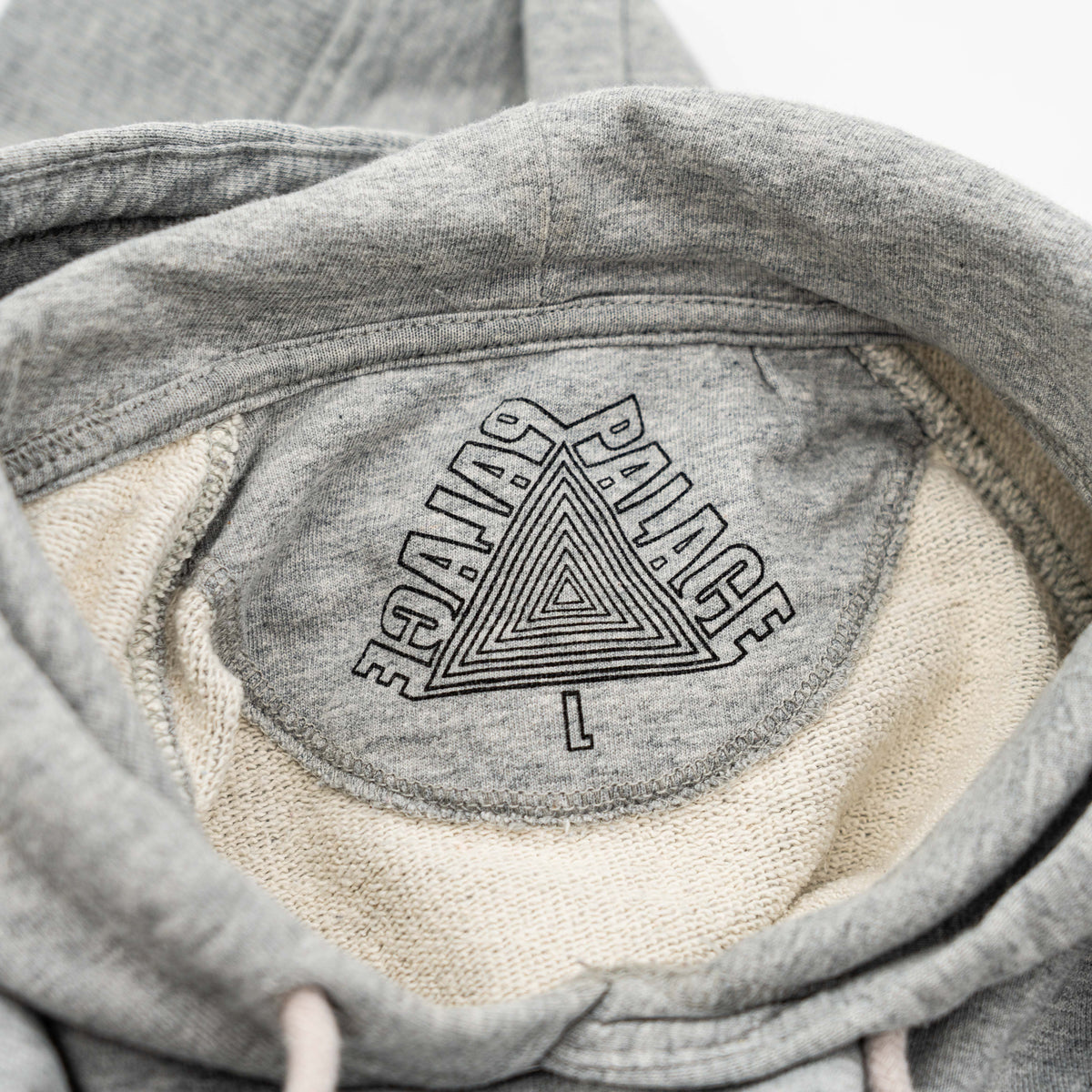 Palace grey pullover hoodie with tropical Tri-Ferg back graphic and white chest logo, laid flat on a neutral background.