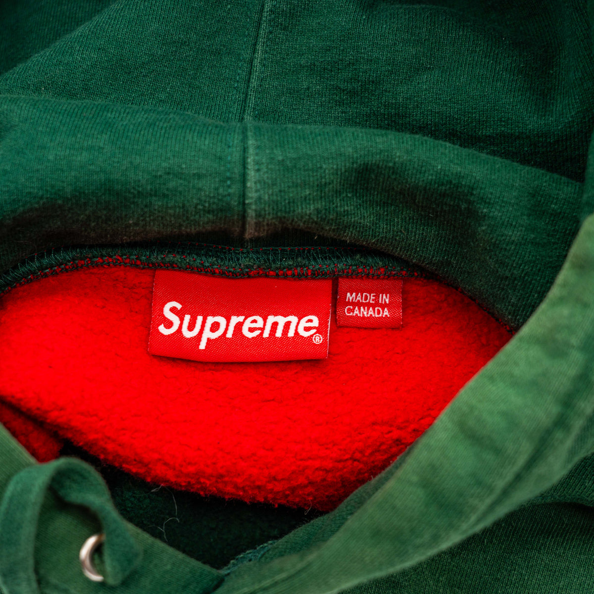 Supreme S Logo Split Hooded Sweatshirt in dark green and red, featuring front 'S' patch and a bold colour contrast.