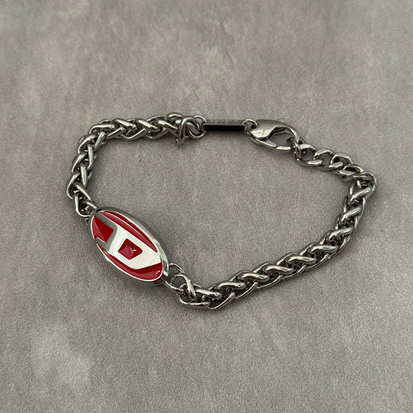 Diesel red lacquer and stainless steel chain bracelet with bold logo centerpiece and lobster clasp closure.