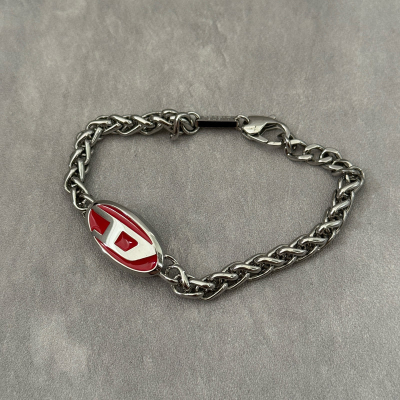 Diesel red lacquer and stainless steel chain bracelet with bold logo centerpiece and lobster clasp closure.